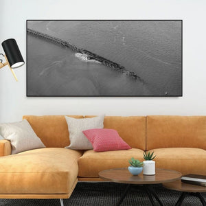 Geometric industrial framework forms a narrow diagonal across a broad expanse of water.