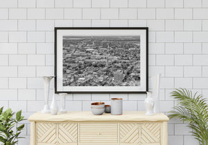 An elevated view reveals Charleston buildings and intersecting streets beneath a distant horizon.