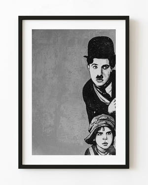 Monochrome photograph of Charlie Chaplin and a boy painted on a textured Cuban wall.