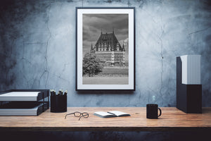 Chateau Frontenac architecture contrasts with textured clouds and soft foliage in Quebec City.