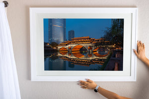 Chengdu cityscape behind glowing Anshun Bridge