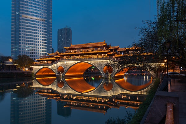 Reflective view of Chengdu's historic bridge over Jin River