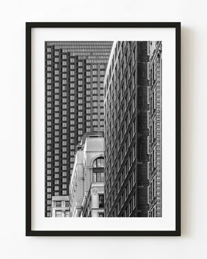 Black and white Chicago architecture photograph with layered office buildings and repeating window grids.