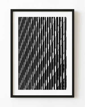 Black and white Chicago building facade with repeating geometric lines and dark window bands.
