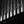 Light catches repeating vertical details along a Chicago building above deep shadows at night.