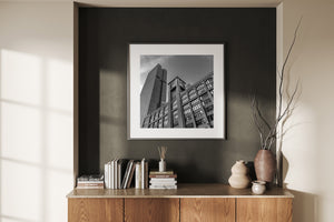 Low-angle monochrome photograph of historic and modern Chicago buildings beside the river.
