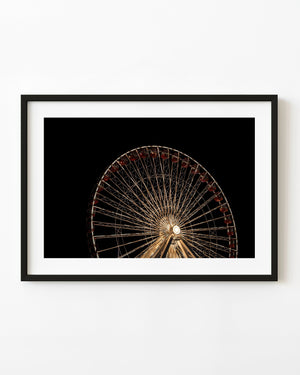 Chicago Ferris wheel glows with warm lights against a black night sky.