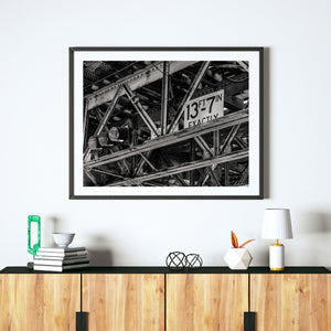 Chicago elevated railway detail showing aged riveted steel and crisscrossing structural beams.