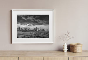 Storm clouds fill the sky over Chicago’s waterfront buildings in this black and white landscape.