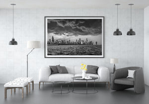 Bright breaks in the clouds contrast with dark storm layers above the Chicago skyline.