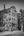Painted faces and large hands cover the facade of a Chicago building in monochrome.