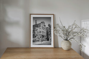 Monochrome photograph of a Chicago mural with expressive figures painted across weathered brick.