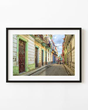 Colour Havana street photograph with children among weathered pastel buildings and mint-green doorways.