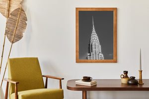 Monochrome view of the Chrysler Building with repeated facade windows beneath its distinctive crown.