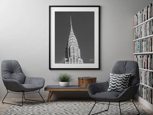 Vertical black and white photograph of the Chrysler Building’s upper stories, arched crown and pointed spire.
