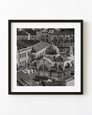 Black and white photograph of the Church of St Blaise dome among Dubrovnik’s tightly packed rooftops.