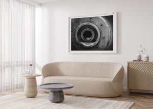 Horizontal industrial photograph of a circular machine detail with textured metal and a dark centre.