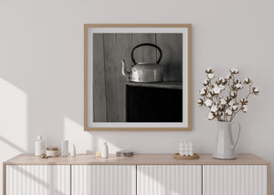 Clarence Town still life with an old metal teapot against vertical wood panels.
