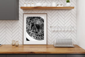 Monochrome Thunderbird wheel photograph with a polished hub and smooth white tyre band.