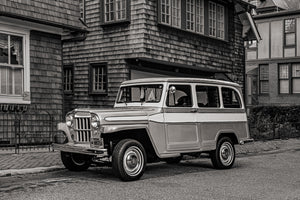 Classic Willys Wagon in front of historic shingle-style home