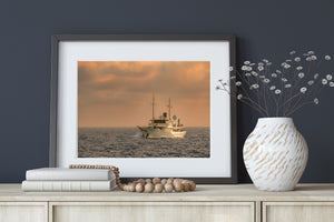 Two slender masts rise from a white classic yacht against soft evening light in the Bahamas.