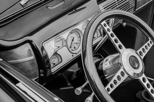 Vintage Ford interior with chrome steering wheel and analog gauges