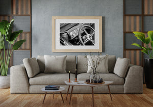 Monochrome classic car dashboard with steering wheel detail