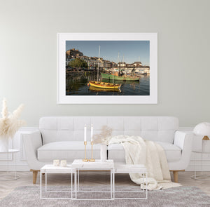 Horizontal photograph of Cobh Harbour with boats, reflections and warm evening colours.