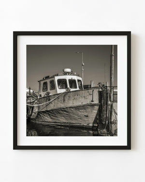 Black and white photograph of a weathered fishing boat moored in Cobh, Ireland.