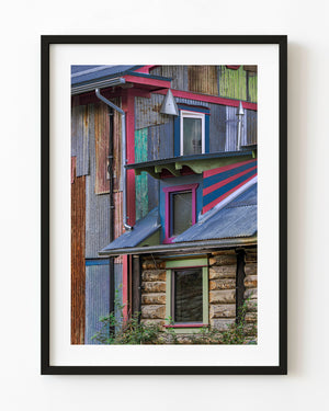 Colourful weathered building detail with red trim and timber walls in Dawson City, Yukon.