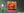 Warm golden cloth and translucent red bands overlap across a close view of prayer flags.