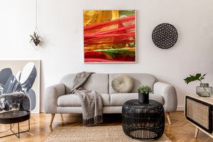 Green folds interrupt rows of red and gold fabric carrying dark printed symbols.