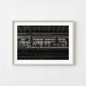 Amsterdam Central Station night train platform with waiting commuters monochrome