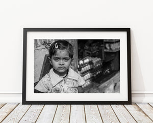 Horizontal street photograph of a young Coonoor girl with detailed shop surroundings.