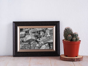 Horizontal black and white photograph of Coonoor housing with dense rooftop textures.