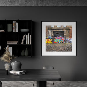 moss and cobblestones near graffiti-covered Cooperage