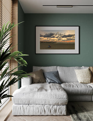 A panoramic Florida seascape shows a pier, open beach and two figures facing the horizon.