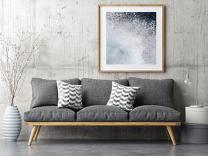 Crashing ocean water fills the photograph with scattered droplets and white spray.