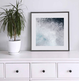 Square water photograph capturing layered foam, turquoise tones and a burst of ocean spray.