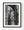 A weathered stone archway frames a narrow Croatian lane in a vertical black and white photograph.