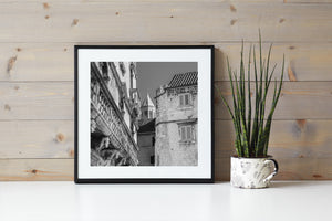 Croatian old town buildings form layered rooflines and walls around a slender tower.