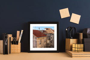 Old Croatian architecture combines warm stone textures with red rooftops and blue sky.