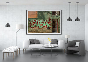 The word CUBA fills an aged house facade with sweeping letters and red outlines.