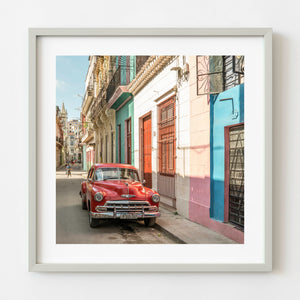 Red vintage Chevrolet parked on a Havana street