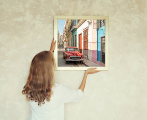 Colorful street scene with vintage car in Cuba