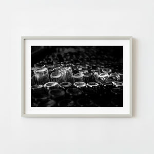 Black and white still life photograph of glass bottles in a Cuban rum factory