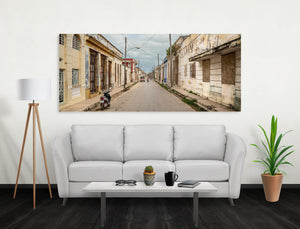 Doors, shutters and overhead wires create a layered view along a Cuban residential street.