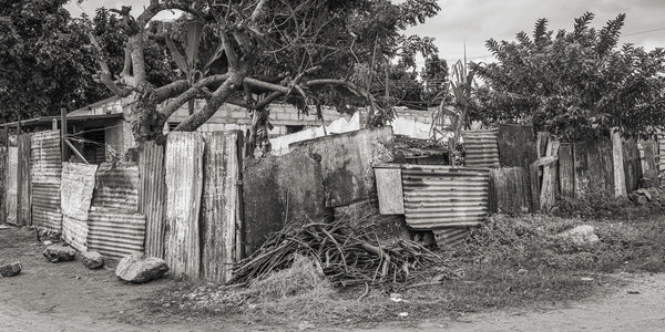 Weathered tin sheets fencing Cuban home