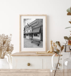 Curley’s Tap street photograph captures roadside lettering and a bench beneath a striped pub awning.