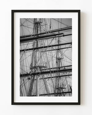 Cutty Sark masts and intersecting rigging form a dense geometric pattern in black and white.